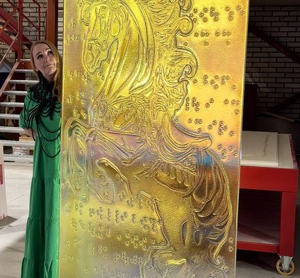 Sini Majuri, the artist, with the finished Unicorn artisan glass piece by Essis master artsans