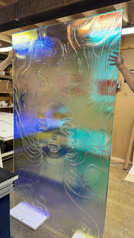 Woman artisan glass piece with rainbow effect by Essis by Lasilinkki